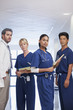 Portrait of serious doctor and nurses in hospital corridor