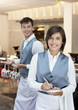 Portrait of smiling waiter and waitress in restaurant