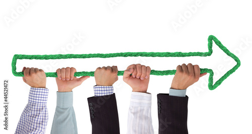 Photo: Hands holding green arrow Hands holding green arrow