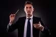 Young businessman directing with a conductor's stick