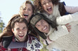 Photo: Portrait of smiling couples piggybacking Portrait of smiling couples piggybacking