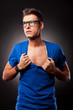 young man ripping his blue shirt
