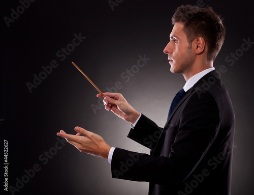 Photo: Side view of a young business man directing Side view of a young business man directing