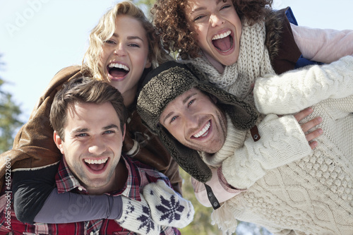 Photo: Portrait of smiling couples piggybacking Portrait of smiling couples piggybacking
