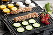 meat skewers and vegetables on electric grill