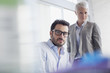 Photo: Portrait of confident businessman and businesswoman in office Portrait of confident businessman and businesswoman in office