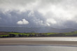 View of sun shining over estuary in Borth Y Gest, North Wales 