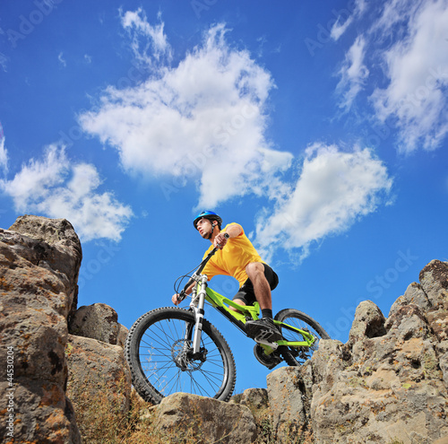 Photo: A person riding a mountain bike on a sunny day A person riding a mountain bike on a sunny day