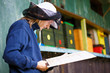 Beekeeper by an apiary checking the health of his bees