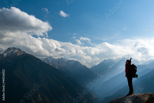 Photo: Climbing young adult at the top of summit Climbing young adult at the top of summit