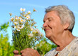 Senior woman with flowers.
