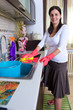 Photo: beautiful young housewife cleaning the furniture in the kitchen beautiful young housewife cleaning the furniture in the kitchen