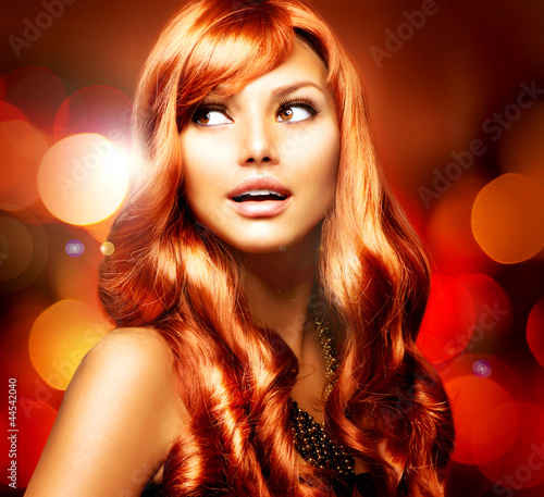 Photo: Beautiful Girl With Shiny Red Long Hair over Blinking Background Beautiful Girl With Shiny Red Long Hair over Blinking Background