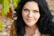 Closeup of brunette woman with blue eyes, outdoors portrait. Per