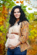 Young beautiful pregnant woman in autumn