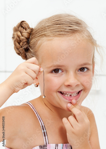 Photo: Little girl with her first missing milk tooth Little girl with her first missing milk tooth