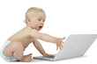 Photo: Baby and laptop isolated on white Baby and laptop isolated on white