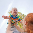 Photo: baby with Down syndrome is happy and flying up baby with Down syndrome is happy and flying up