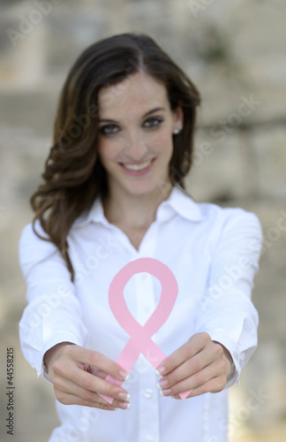 Photo: woman holding breast cancer support ribbon woman holding breast cancer support ribbon
