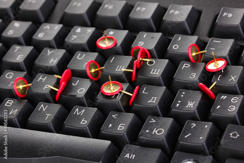 Photo: Painful typing, pins on keyboard close-up Painful typing, pins on keyboard close-up
