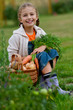 Autumn gardening - lovely girl with picked vegetables in basket