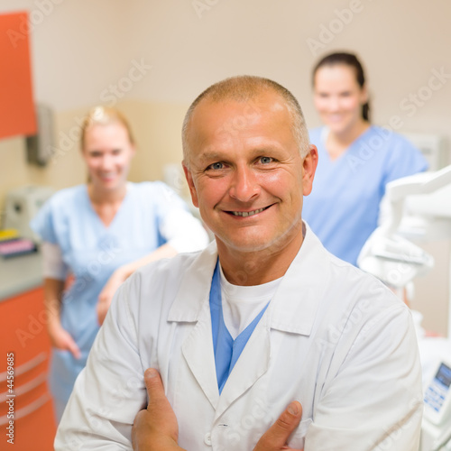 Photo: Smiling dental surgeon posing with nurses Smiling dental surgeon posing with nurses
