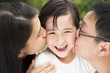 Photo: happy asian family in kissing happy asian family in kissing