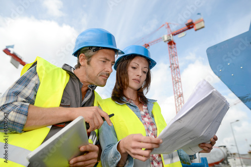 Photo: Construction manager and engineer working on building site Construction manager and engineer working on building site