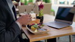 Businessman eating lunch in cafe, outdoor