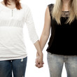 beautiful red and blond haired girls holding hands close up