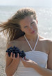 woman with grapes on a beach
