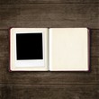 open diary book with photo frame on old wooden table