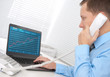 business man working on a laptop with Financial diagram