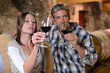 Couple of winemakers tasting red wine