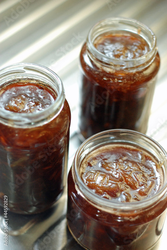 Photo: Freshly poured rhubarb jam in jars. Freshly poured rhubarb jam in jars.