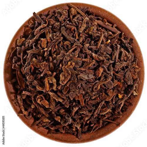 Photo: Dry black tea in a clay cup from above Dry black tea in a clay cup from above