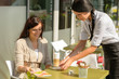 Waitress serve woman latte at cafe bar