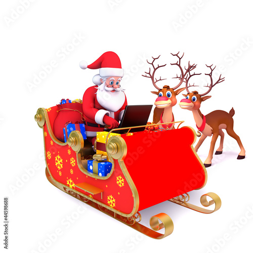 Photo: santa is with his sleigh and laptop santa is with his sleigh and laptop