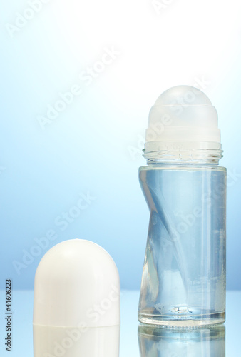 Photo: deodorant on blue background deodorant on blue background