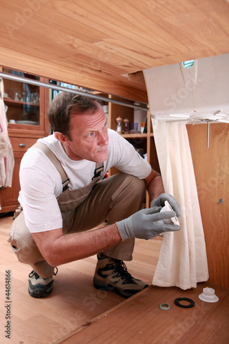 Photo: Plumber fixing a sink Plumber fixing a sink