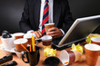 Businessman Seated at His Messy Desk