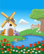Green garden with beautiful spring flowers, lake and windmill