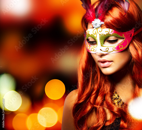 Photo: Masquerade. Beautiful Girl in a Carnival mask Masquerade. Beautiful Girl in a Carnival mask