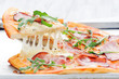 Gourmet rustic pizza lifted melted mozarella cheese