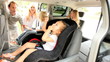 Parents Putting Children Family Car Seats