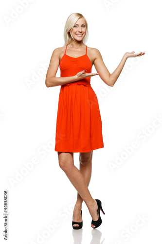Photo: Full length of woman showing copy space on her palm Full length of woman showing copy space on her palm