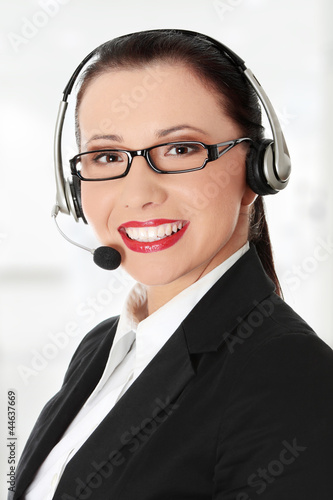 Photo: Smiling young woman with headset and microphone. Smiling young woman with headset and microphone.
