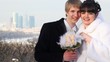 Pair of newly-married couple caress and kiss
