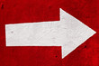 White arrow on the red concrete.