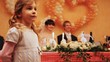 little girl on wedding, behind groom with bride behind table
